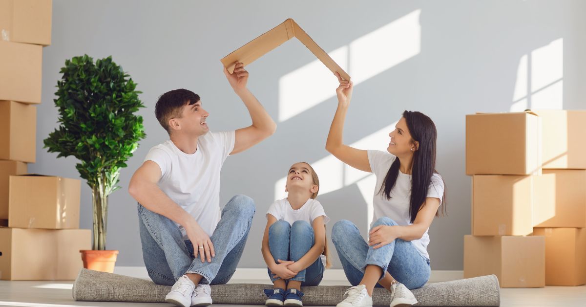 A family moves into a newly constructed house in Austin, surrounded by cardboard boxes.